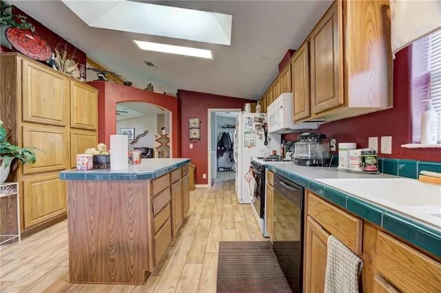 kitchen with range, a center island, vaulted ceiling, light hardwood / wood-style flooring, and dishwasher