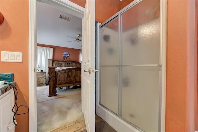 bathroom featuring ceiling fan and walk in shower