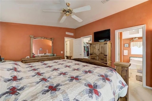 bedroom featuring ensuite bathroom, a spacious closet, ceiling fan, and a closet