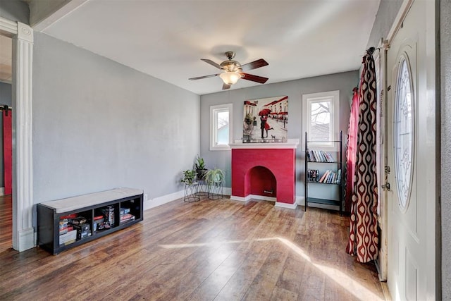 sitting room with hardwood / wood-style flooring, a fireplace, and ceiling fan