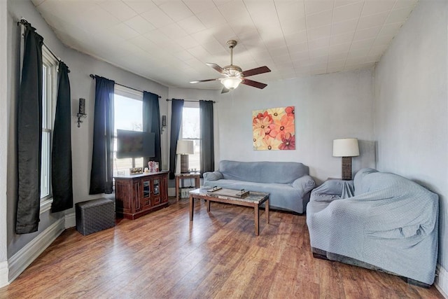 living room with hardwood / wood-style floors and ceiling fan