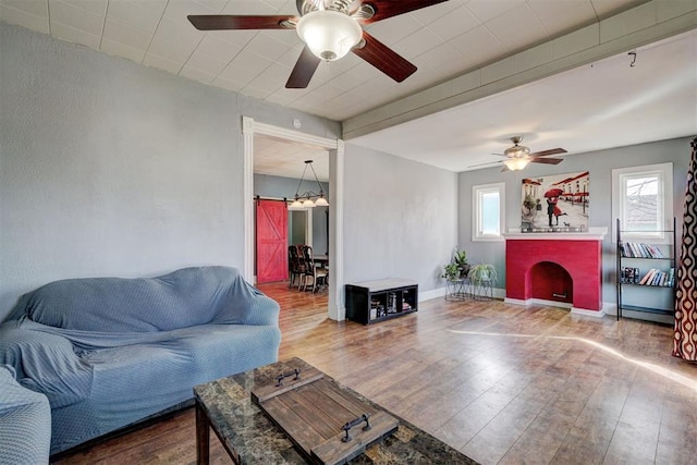 living room featuring hardwood / wood-style floors and a brick fireplace