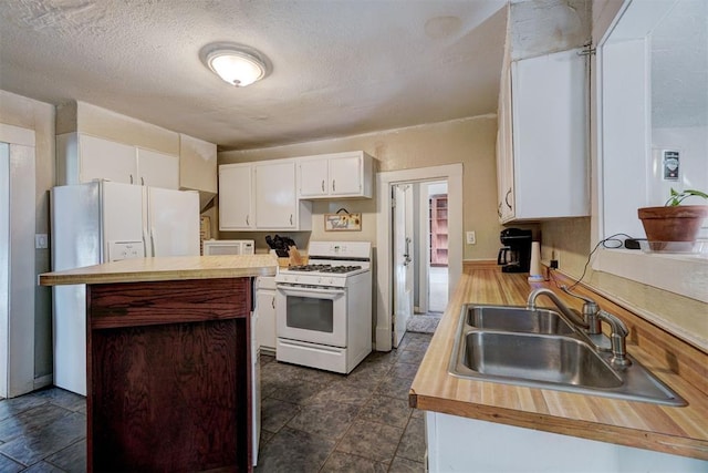 kitchen with white appliances, sink, a textured ceiling, and white cabinets