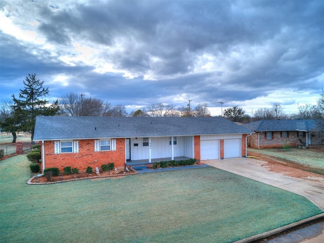 ranch-style house featuring a garage and a front yard