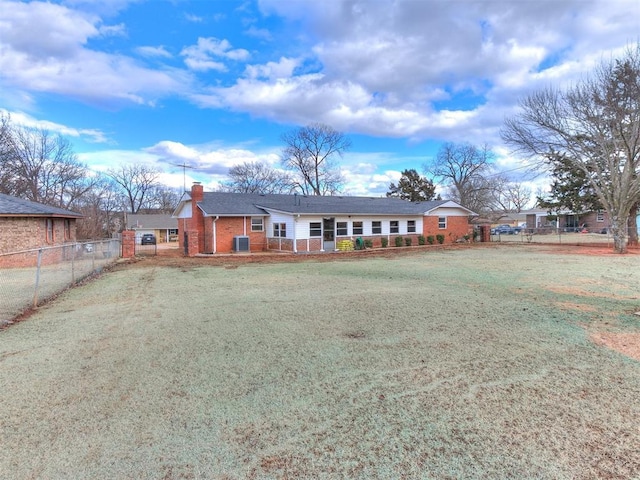 view of front of home featuring a front lawn and central air condition unit