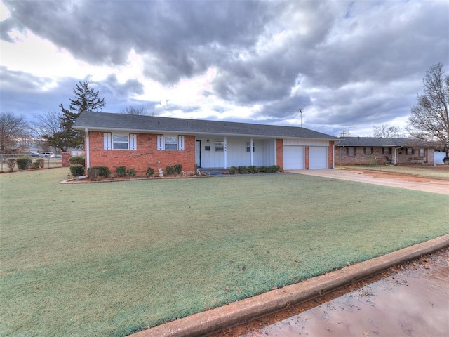 ranch-style house featuring a garage and a front lawn