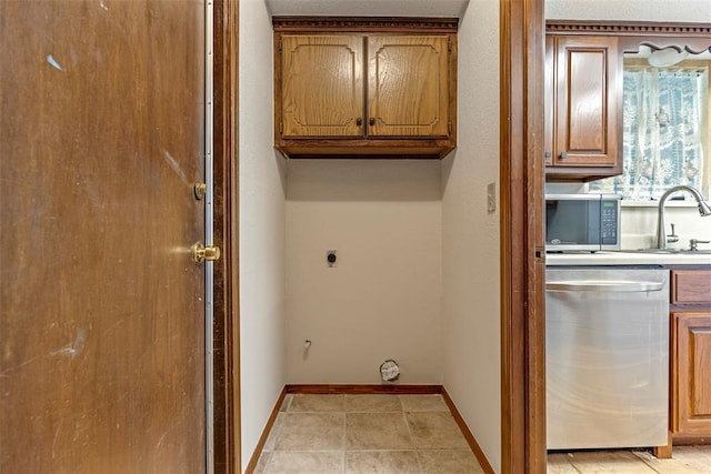 washroom featuring sink, light tile patterned floors, and electric dryer hookup