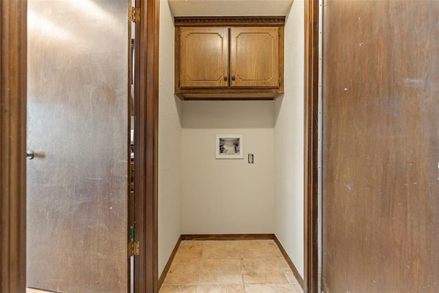 laundry room with hookup for a washing machine and cabinets