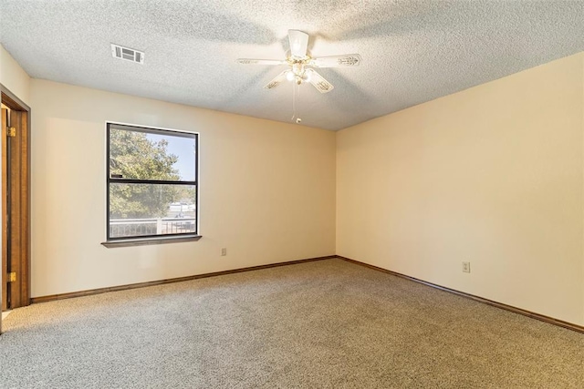 unfurnished room featuring ceiling fan, carpet flooring, and a textured ceiling