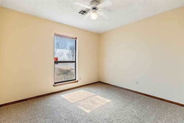 carpeted empty room featuring a textured ceiling and ceiling fan