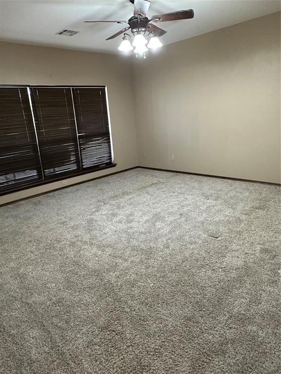 unfurnished room with ceiling fan