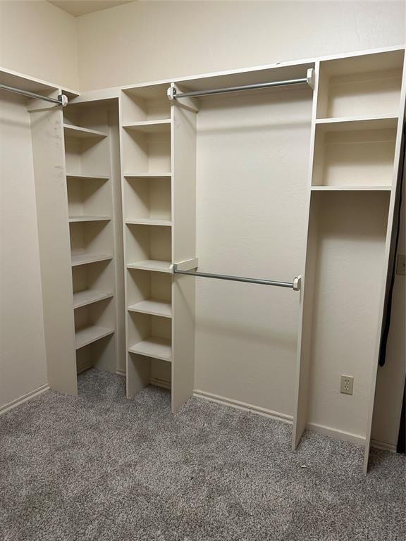 spacious closet with dark carpet