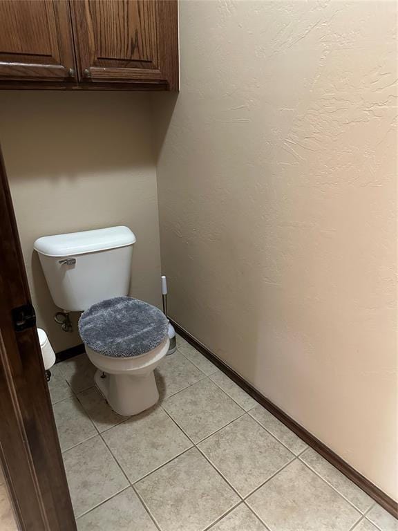 bathroom with tile patterned flooring and toilet