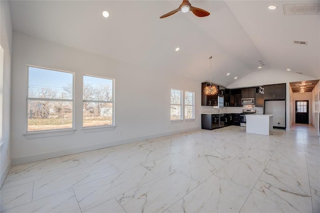 unfurnished living room with sink, vaulted ceiling, and ceiling fan