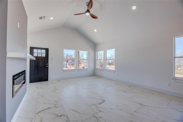 unfurnished living room with ceiling fan and high vaulted ceiling