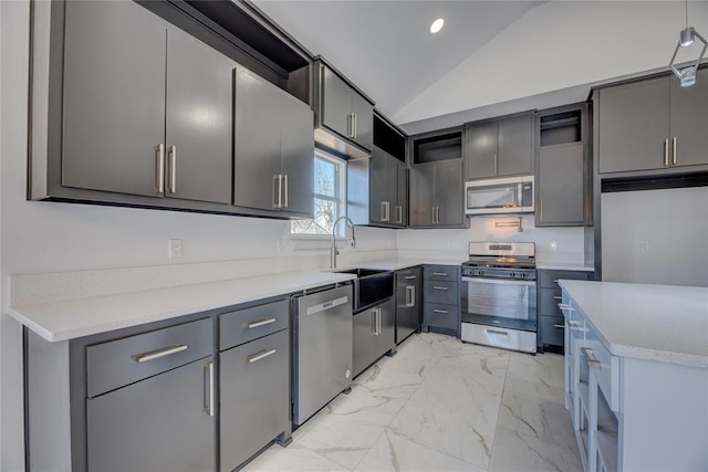 kitchen with lofted ceiling, sink, gray cabinets, and appliances with stainless steel finishes