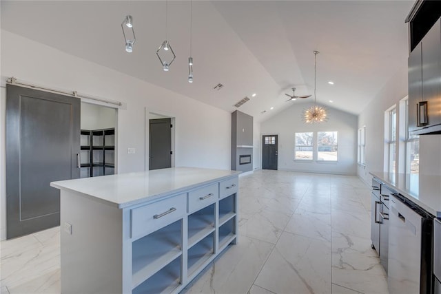 kitchen featuring white cabinetry, a center island, vaulted ceiling, pendant lighting, and a barn door