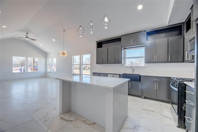 kitchen with sink, decorative light fixtures, plenty of natural light, a kitchen island, and black gas range