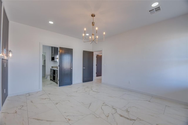 spare room featuring a notable chandelier