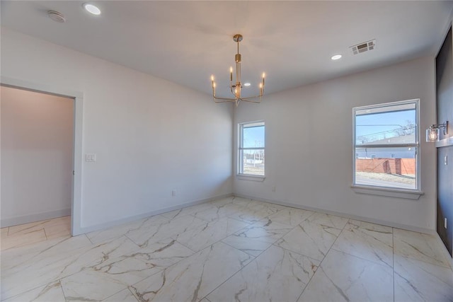 unfurnished room with plenty of natural light and an inviting chandelier