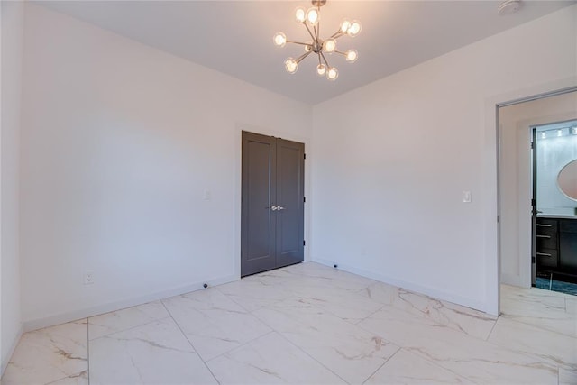 empty room featuring an inviting chandelier