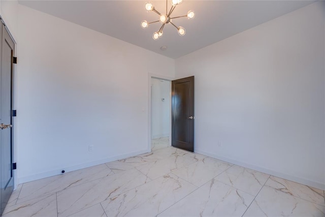 spare room with an inviting chandelier