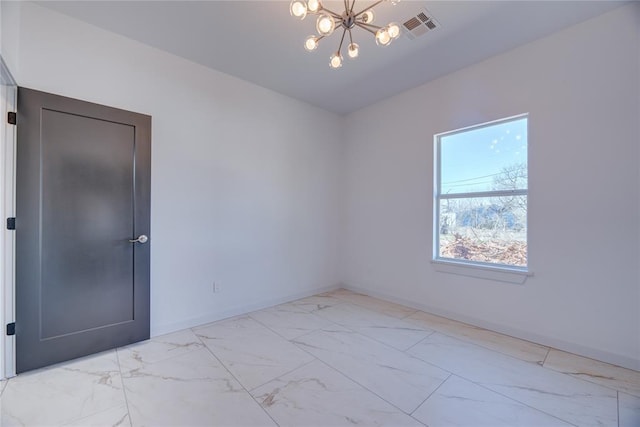 unfurnished room with a chandelier