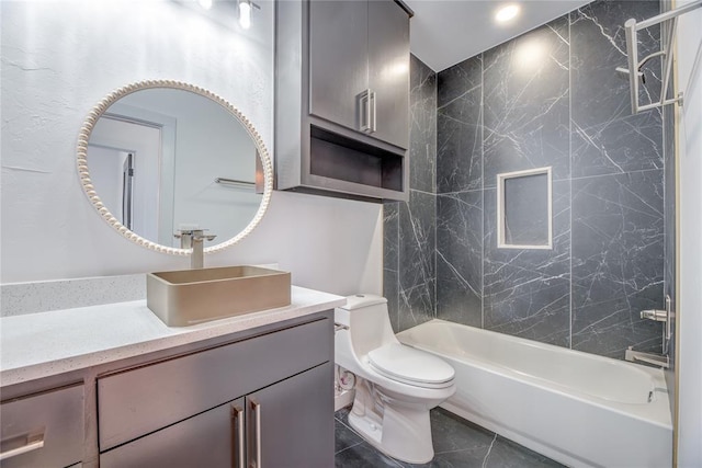 full bathroom with vanity, tiled shower / bath combo, tile patterned floors, and toilet