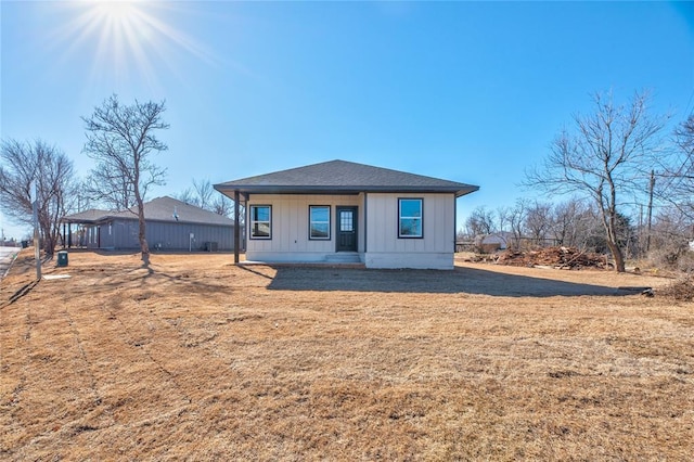 rear view of property with a porch and a lawn