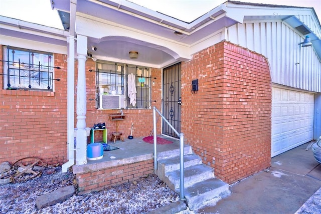 entrance to property with cooling unit, a garage, and covered porch