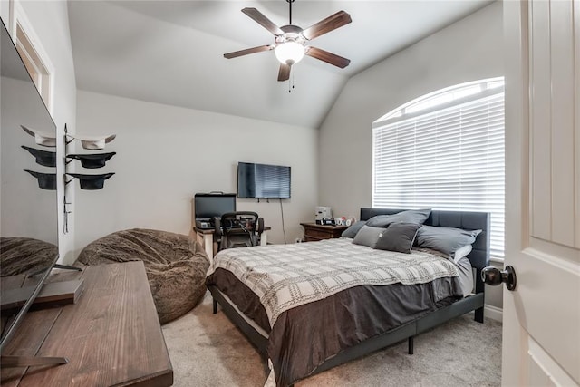 bedroom with ceiling fan, lofted ceiling, and light carpet