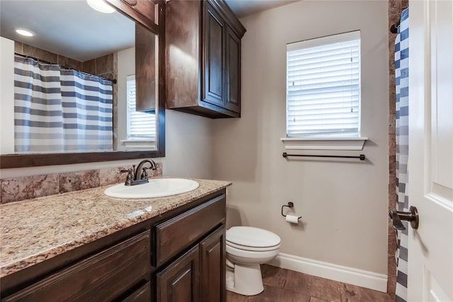 bathroom featuring vanity, tile patterned flooring, and toilet