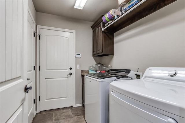 washroom with cabinets and washing machine and clothes dryer