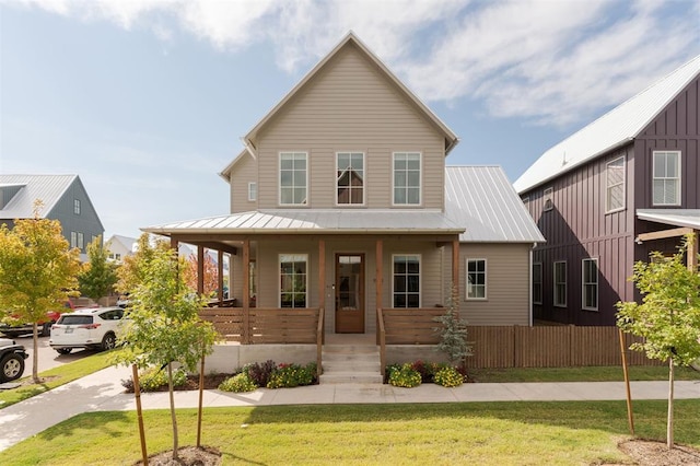 view of front of home featuring covered porch and a front yard