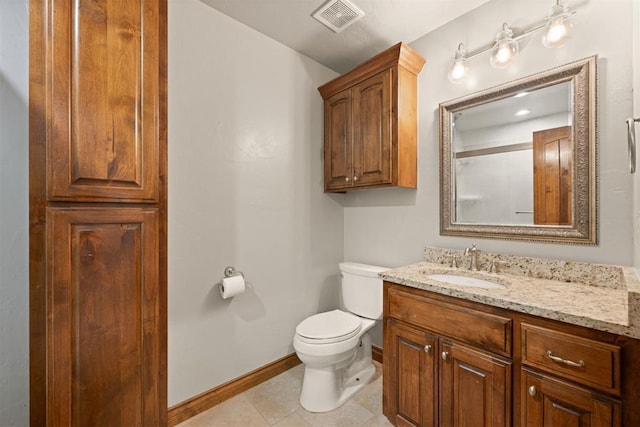 bathroom featuring vanity, toilet, and tile patterned flooring