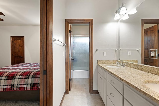 bathroom featuring vanity, combined bath / shower with glass door, and ceiling fan