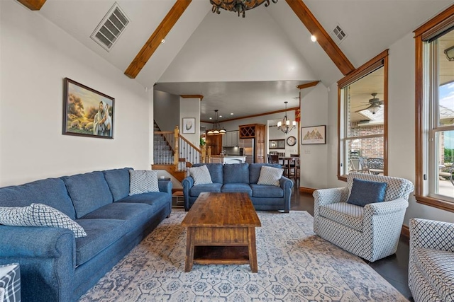 living room featuring a notable chandelier, beam ceiling, and high vaulted ceiling