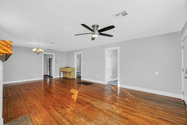 unfurnished living room featuring wood-type flooring and ceiling fan with notable chandelier