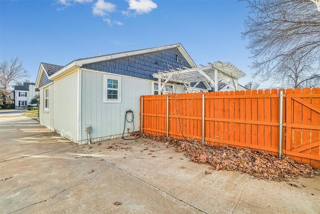 view of side of property with a pergola