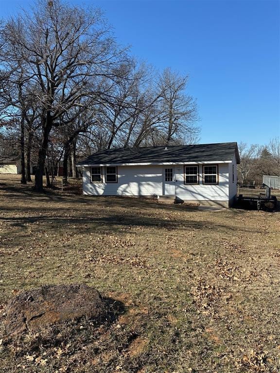 ranch-style home with a front lawn