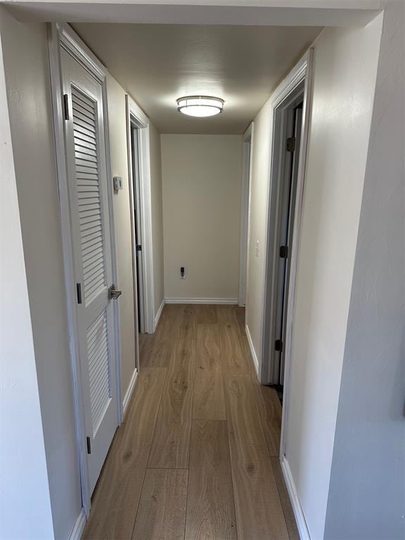 corridor featuring light hardwood / wood-style floors