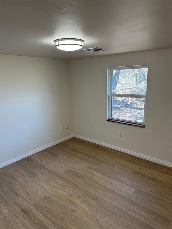 spare room with light hardwood / wood-style floors