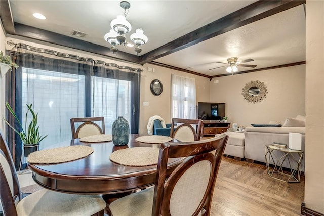 dining space featuring ceiling fan with notable chandelier, crown molding, and light hardwood / wood-style floors