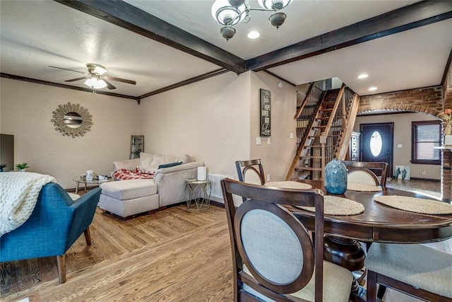 dining room with ceiling fan, ornamental molding, beam ceiling, and light hardwood / wood-style floors