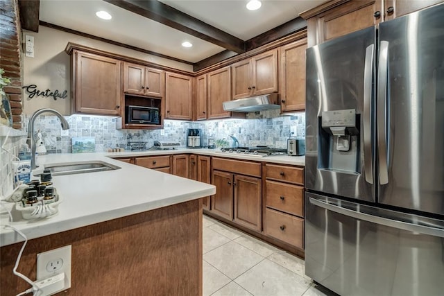 kitchen featuring sink, light tile patterned floors, beam ceiling, stainless steel appliances, and tasteful backsplash