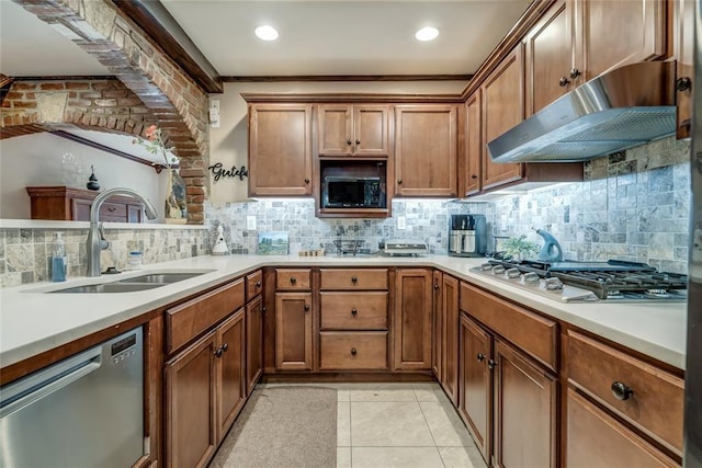 kitchen with sink, light tile patterned floors, ornamental molding, stainless steel appliances, and decorative backsplash