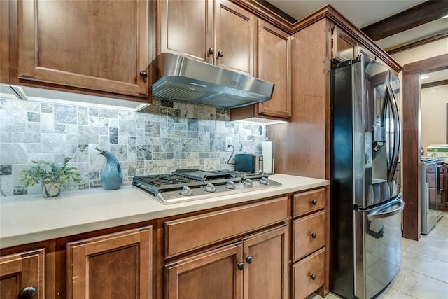 kitchen featuring tasteful backsplash, appliances with stainless steel finishes, and light tile patterned floors