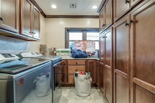 clothes washing area featuring cabinets, crown molding, light tile patterned floors, and independent washer and dryer