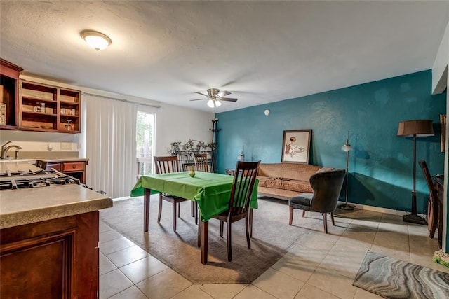 dining room with sink, ceiling fan, and light tile patterned flooring