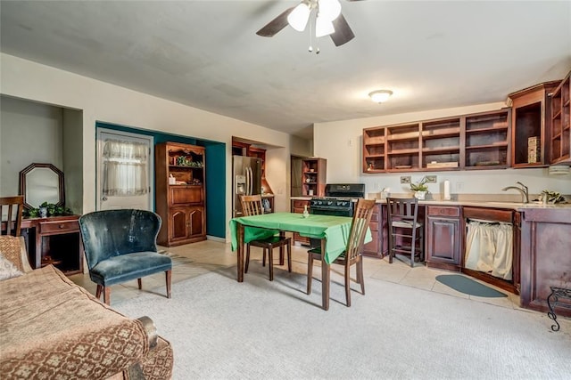 interior space with ceiling fan, light colored carpet, and sink